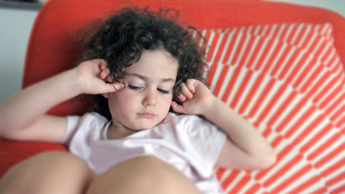 a child experiencing a head ache because of Aicardi syndrome